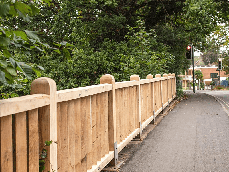 Shows timber balustrades completed along a highway for the council