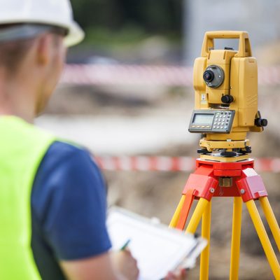 Land Surveyor working with Total Station.