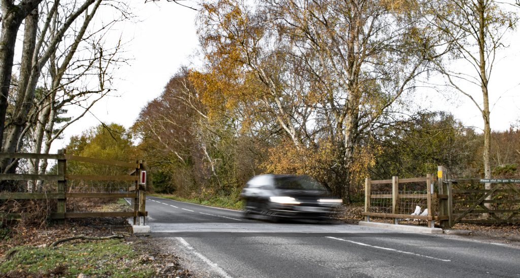 Showing a car going across cattle grid